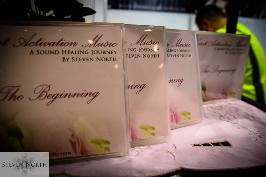 CDs of Steven North's healing music displayed at the event.