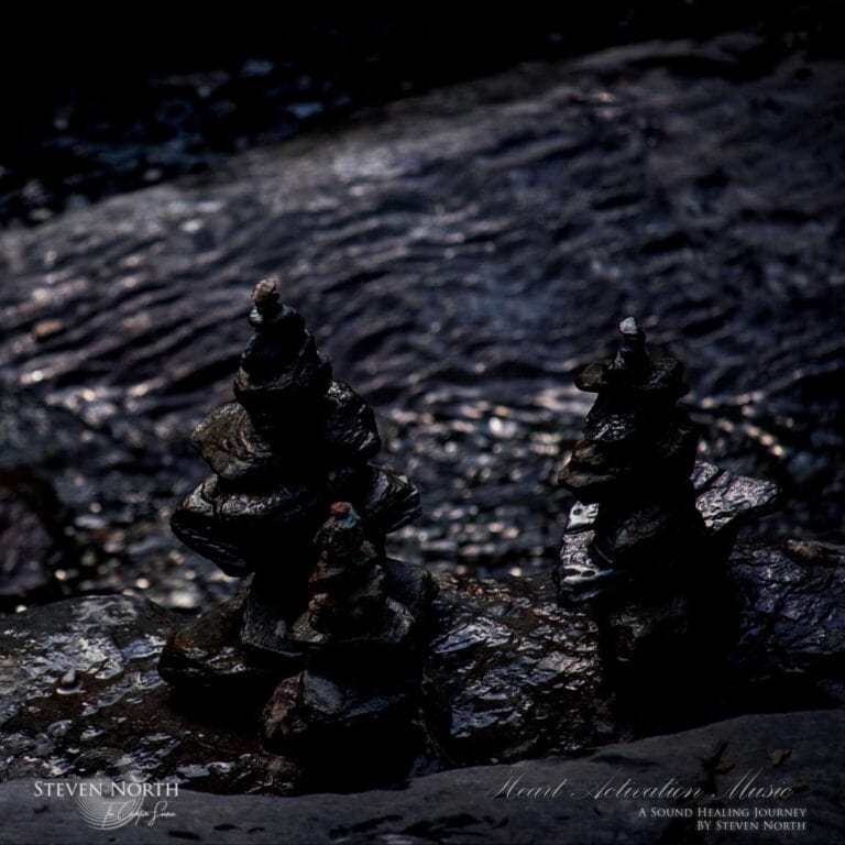 Two balanced meditation stones on a dark, reflective water surface, symbolizing focus and tranquility for deep meditation practices.